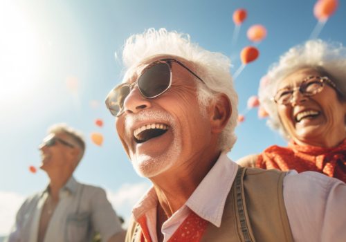 Happy seniors outdoors with balloons in sky.