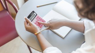 crop-teen-using-calculator-table