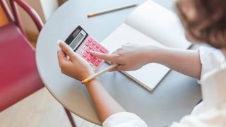 crop-teen-using-calculator-table