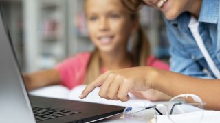 kids-doing-their-homework-laptop-close-up