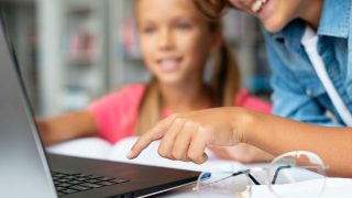 kids-doing-their-homework-laptop-close-up